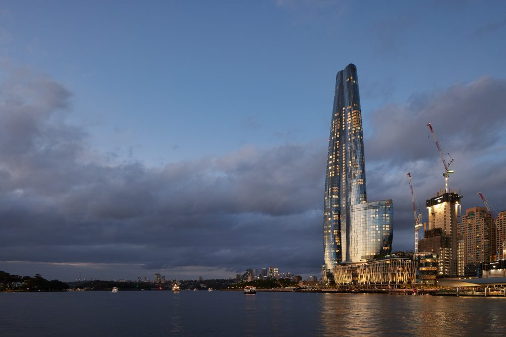Barangaroo harbour at night with crown tower and cranes